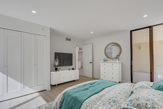 bedroom with hardwood / wood-style flooring and a closet