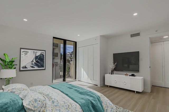 bedroom featuring floor to ceiling windows, access to outside, and light wood-type flooring