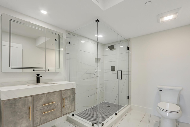 bathroom featuring vanity, a shower with shower door, and toilet