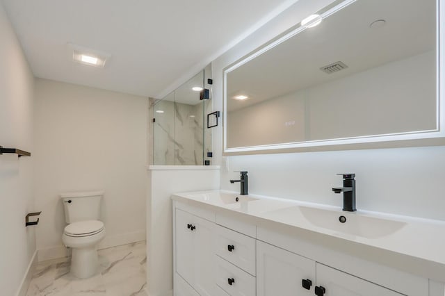 bathroom with vanity, toilet, and a shower with door