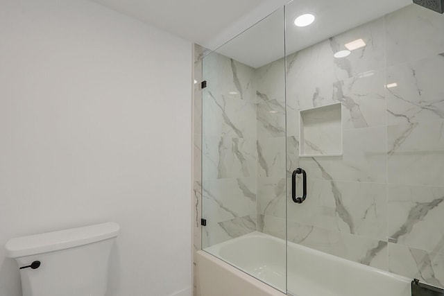 bathroom featuring combined bath / shower with glass door and toilet