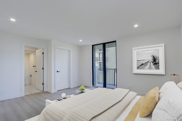 bedroom featuring connected bathroom, access to exterior, and light wood-type flooring