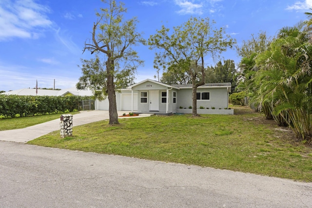 ranch-style home featuring a garage and a front yard