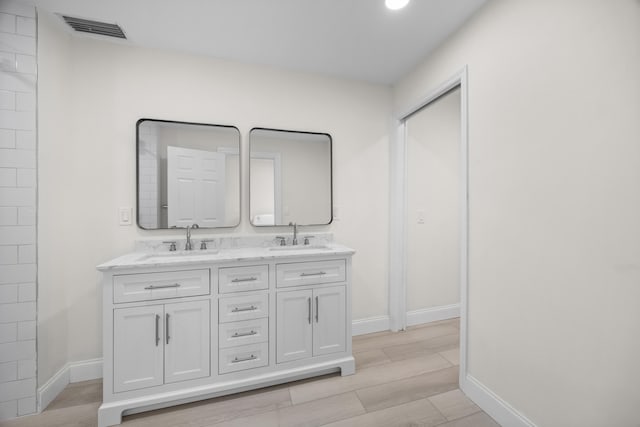 bathroom featuring vanity and wood-type flooring