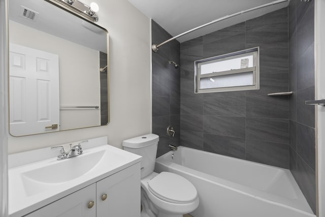 full bathroom with tiled shower / bath combo, vanity, and toilet