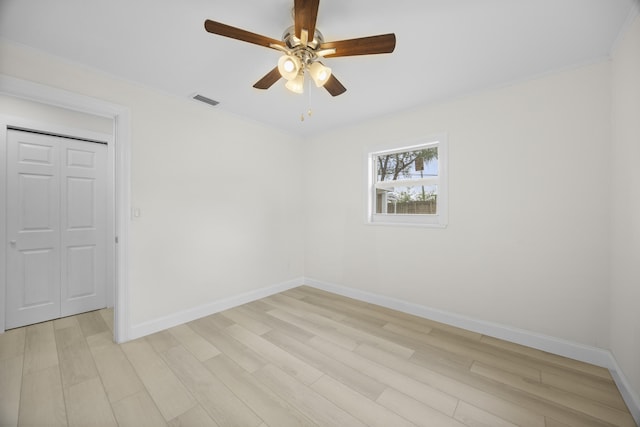 unfurnished room featuring ceiling fan, ornamental molding, and light wood-type flooring