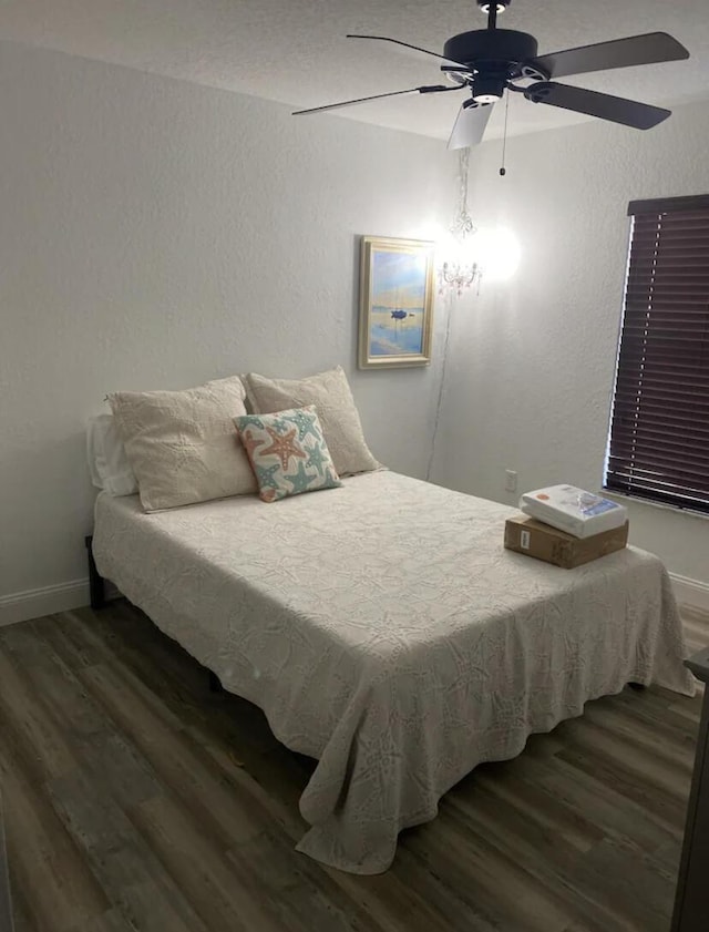 bedroom with ceiling fan and dark hardwood / wood-style flooring