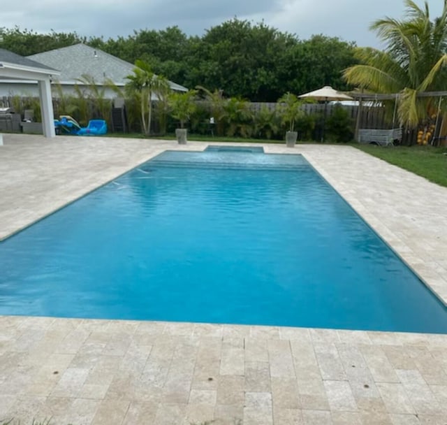 view of swimming pool with a patio area