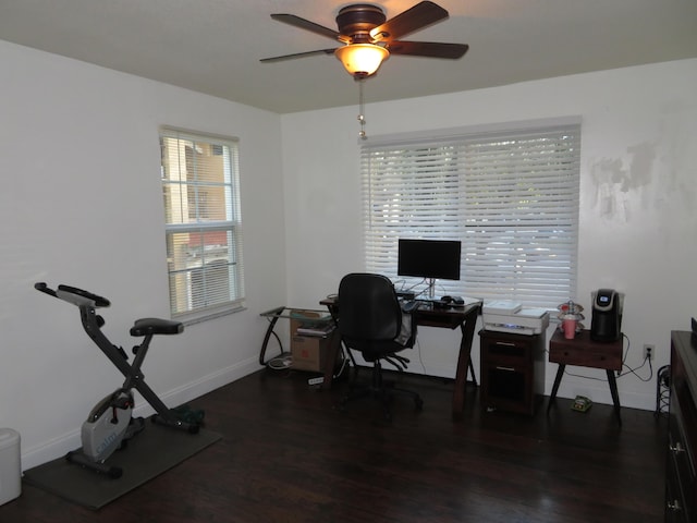 office area with ceiling fan, dark wood finished floors, and baseboards