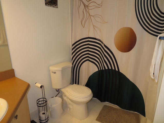 full bath featuring toilet, tile patterned flooring, and vanity