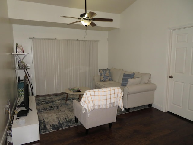 living area featuring dark wood-type flooring, ceiling fan, and baseboards