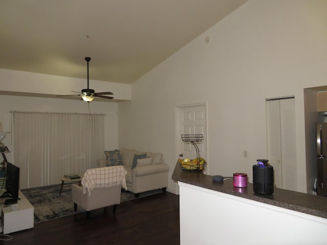 living room with dark wood-type flooring, ceiling fan, and high vaulted ceiling