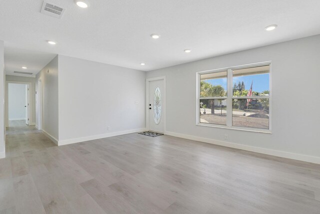 foyer entrance with light wood-type flooring