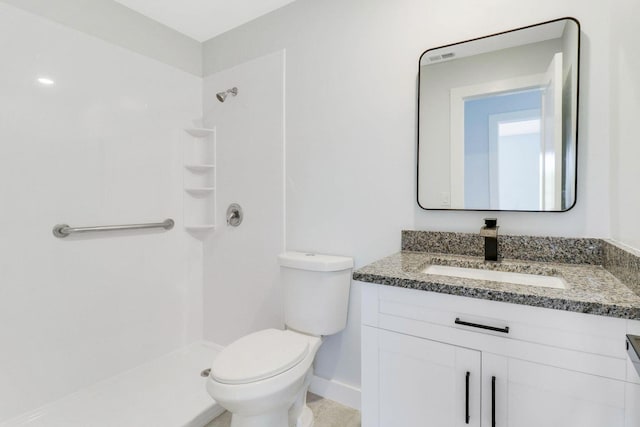 bathroom with walk in shower, vanity, and toilet