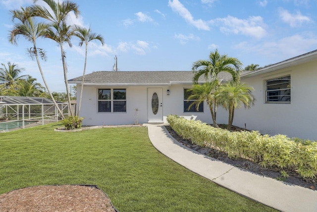 single story home with glass enclosure and a front lawn