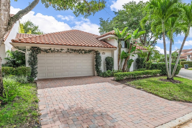 mediterranean / spanish-style home with a garage