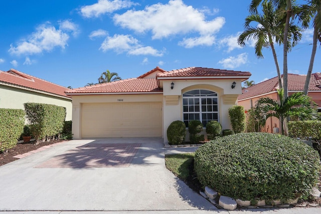 mediterranean / spanish house with a garage