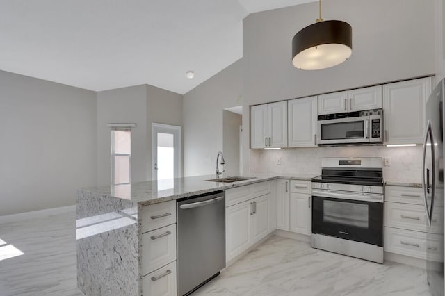 kitchen featuring sink, kitchen peninsula, white cabinets, and appliances with stainless steel finishes