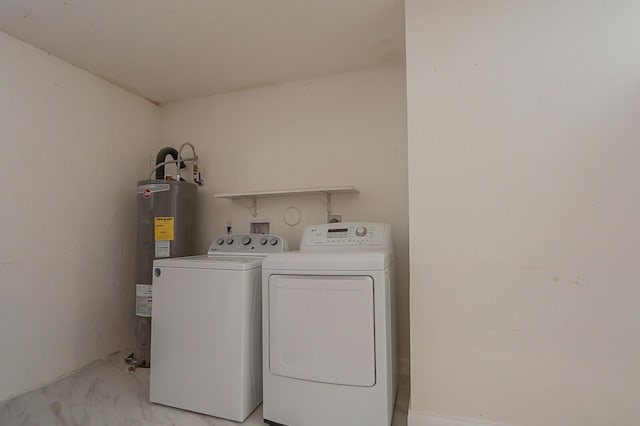 washroom featuring washing machine and dryer and electric water heater