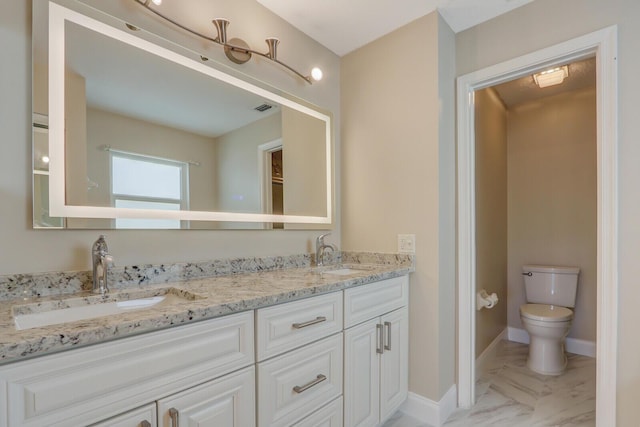 bathroom featuring vanity and toilet