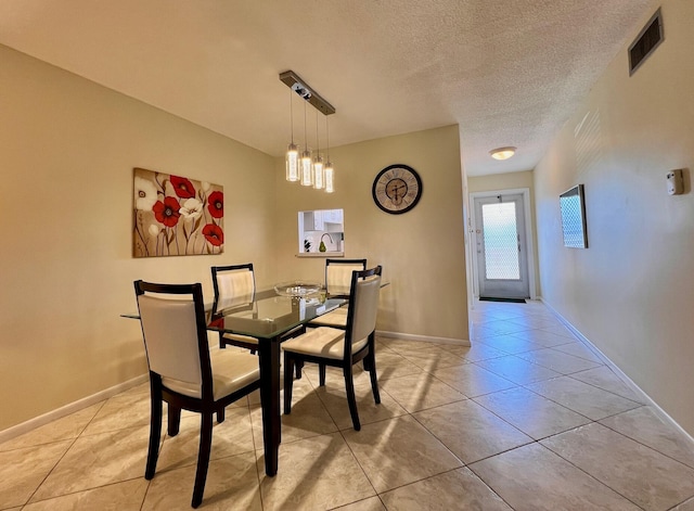 203 Oxford 100, West Palm Beach, FL 33417 - dining area featuring a textured ceiling and light tile patterned floors