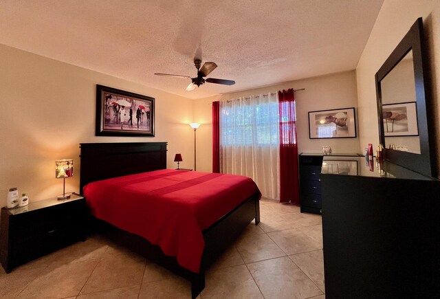 203 Oxford 100, West Palm Beach, FL 33417 - bedroom with ceiling fan, light tile patterned floors, and a textured ceiling