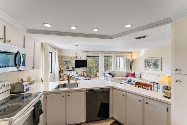 kitchen featuring electric stove, dishwasher, stainless steel microwave, light countertops, and a sink