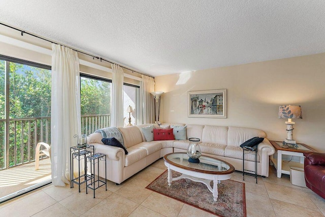 living area with light tile patterned floors and a textured ceiling