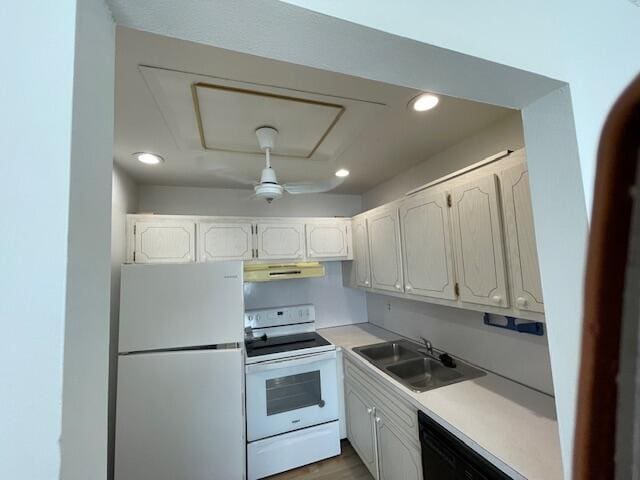 kitchen featuring white cabinetry, sink, and white appliances