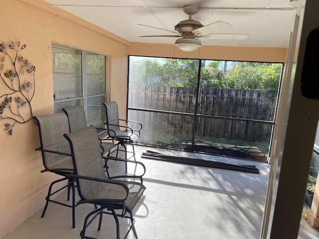 sunroom / solarium with a ceiling fan