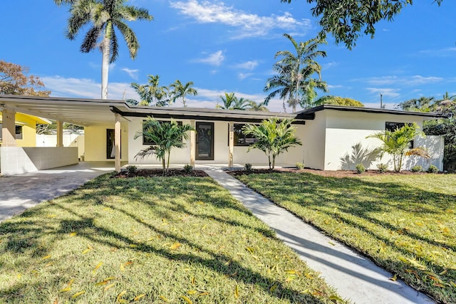 single story home with a front lawn and a carport