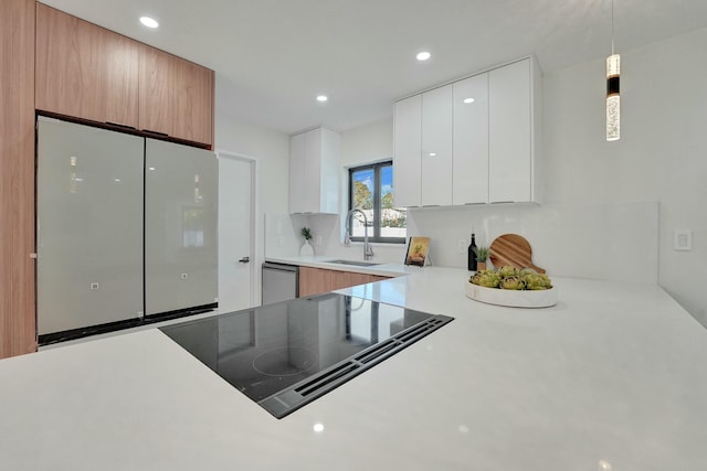 kitchen with pendant lighting, white cabinetry, sink, dishwashing machine, and black electric cooktop