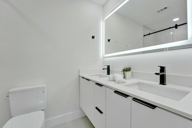 bathroom featuring vanity, toilet, and a shower with door