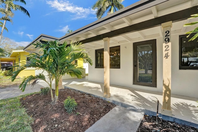 property entrance featuring a porch