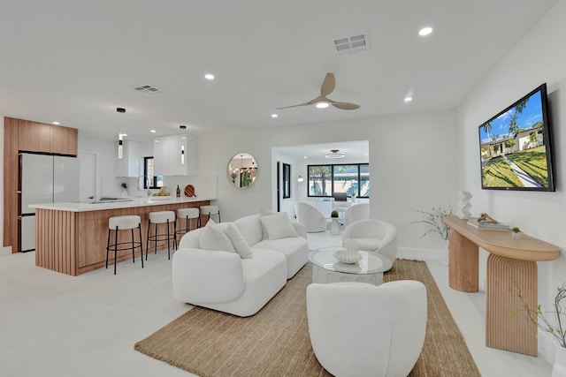 living room featuring sink and ceiling fan