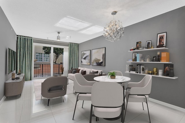 dining space with light tile patterned floors, baseboards, a textured ceiling, and ceiling fan with notable chandelier