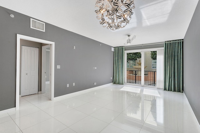 unfurnished room with light tile patterned floors, baseboards, and visible vents