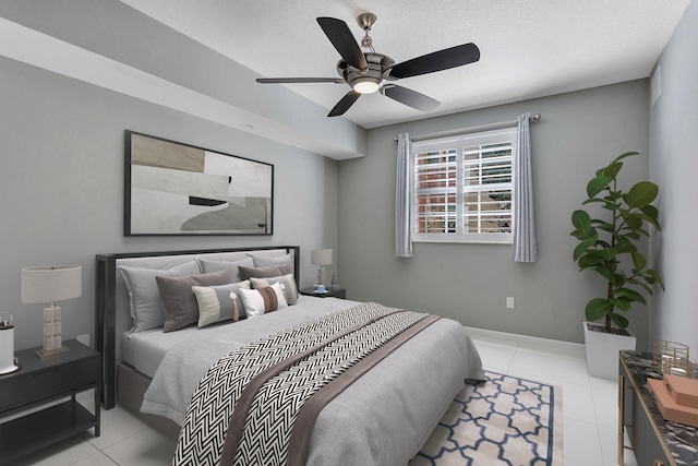 tiled bedroom featuring ceiling fan and baseboards