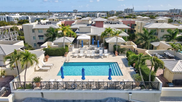 pool with a patio area and fence