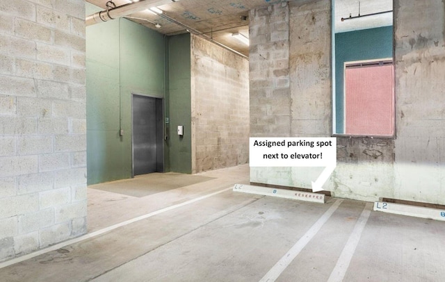 bathroom with concrete block wall and elevator