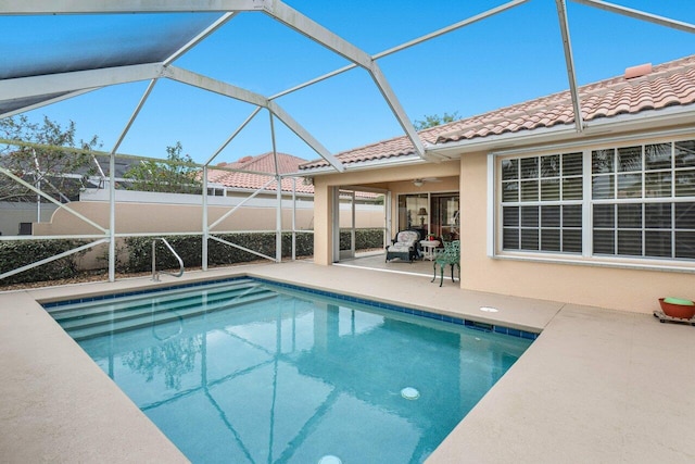 view of pool featuring ceiling fan, a lanai, and a patio area