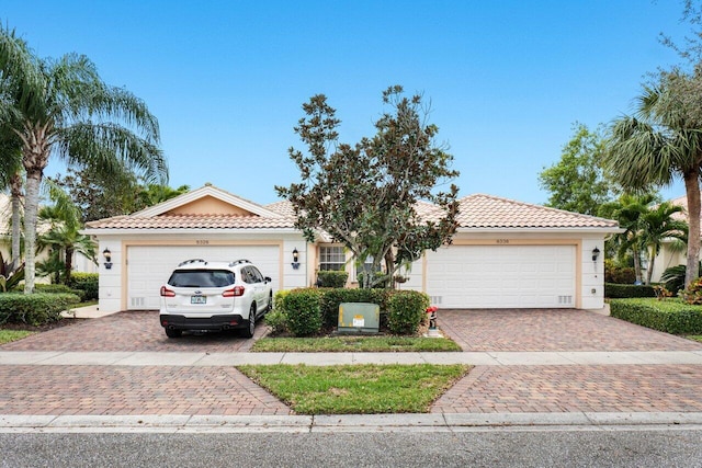 mediterranean / spanish home featuring a garage