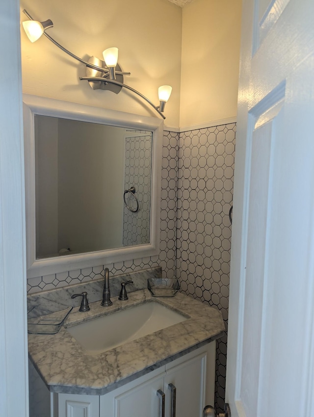 bathroom featuring tasteful backsplash and vanity