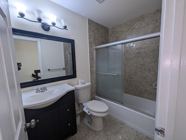 full bathroom featuring enclosed tub / shower combo, vanity, toilet, and tile patterned floors