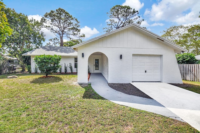 ranch-style home featuring a garage and a front lawn