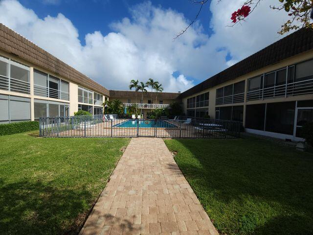 view of swimming pool featuring a patio and a lawn