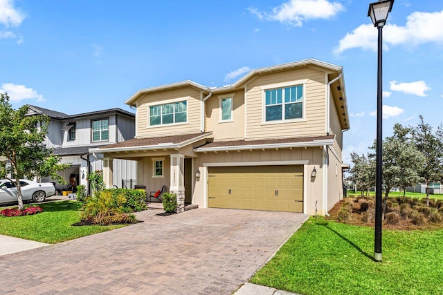 view of front of house with a porch, a garage, and a front lawn