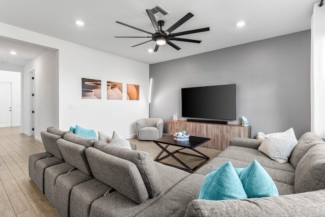 living room with light hardwood / wood-style floors and ceiling fan