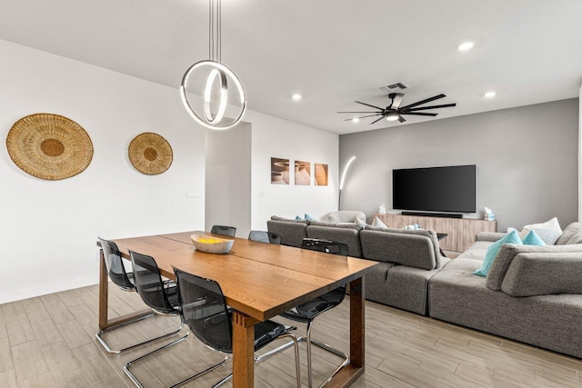 dining space with ceiling fan and light hardwood / wood-style floors