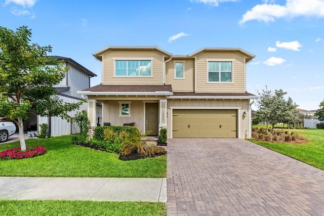 view of front of home featuring a garage and a front yard